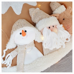 Close-up of knit Christmas ornaments featuring snowman, santa, and reindeer with sequins