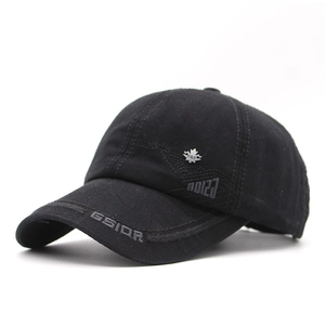 Detail view of black cotton baseball cap featuring silver leaf badge and GSIOR embroidery