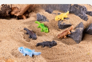 Detailed view of colorful miniature resin lizard figurines in a desert garden setting