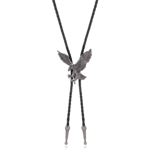 Detail of western bolo tie with eagle pendant and black braided leather rope