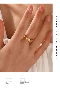 Detail of 18K gold-plated stainless steel ring with X-shaped crossover chain design