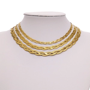 Detailed view of triple-layered golden woven snake chain necklace on white jewelry bust