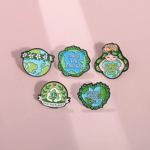 Set of 5 environmental enamel pins with Earth Day themes on a soft pink background