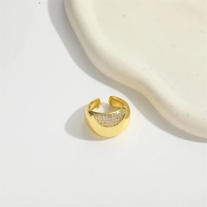 Detail shot of golden open ring featuring a sparkling micro-pave diamond inset on metal