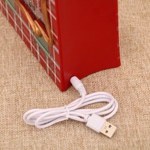 Detail view of the USB power port and cable connection for the Christmas music box light