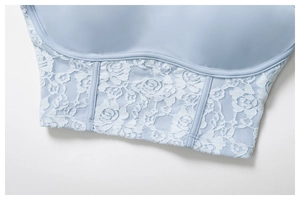 Detail of light blue lace sports bra showing rose embroidery and boning structure