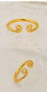 Detail of golden adjustable ring with traditional vintage cloud patterns and engraving