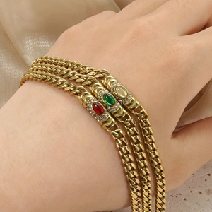 Vintage gold Cuban link bracelet featuring colorful oval gemstones and micro-pave crystals