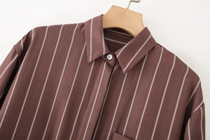 Detail of a brown striped long sleeve shirt showing the lapel collar and chest pocket
