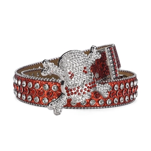 Detail of red rhinestone studded belt with punk skull buckle and sparkling crystals