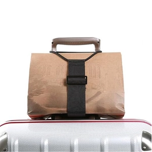 Adjustable elastic luggage strap securing a carry-on bag to a silver suitcase handle