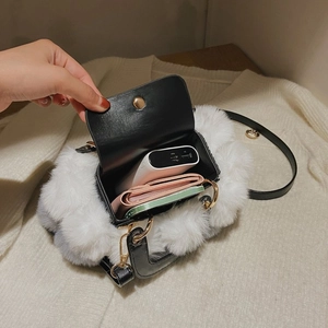 Interior view showing capacity of black and white plush faux fur tote bag with leather handle
