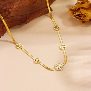 Detail of gold tree of life pendants on a snake chain necklace with sparkling crystals