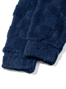 Macro shot of navy blue heavyweight sherpa fleece cuffs with soft plush texture