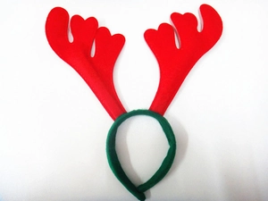 Detail of red reindeer antlers headband with green felt band and festive bell decor