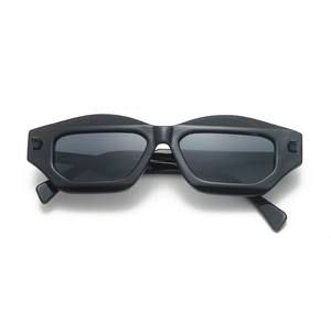 Front view of black polygon geometric sunglasses with wide matte temples on white background
