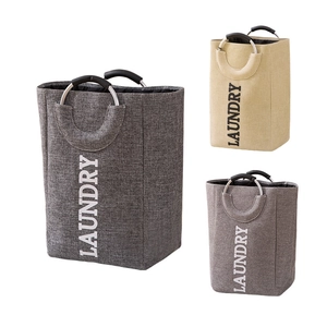 Three large laundry baskets in grey and beige with soft-padded round aluminum handles