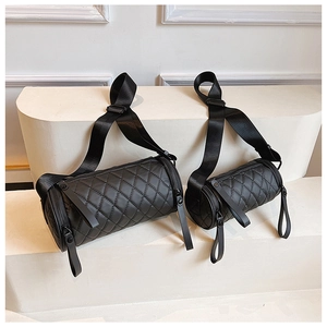 Comparison of large and small black quilted cylinder crossbody bags on white display steps