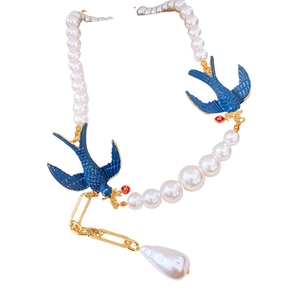 Baroque pearl necklace with blue enamel swallows and gold tassel in vintage style
