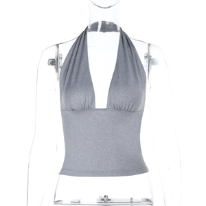 Detailed view of grey shimmer fabric on women's halter deep V-neck crop top vest