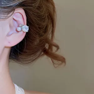 Sparkling zircon star ear cuff with white pearl accent on a silver-plated setting