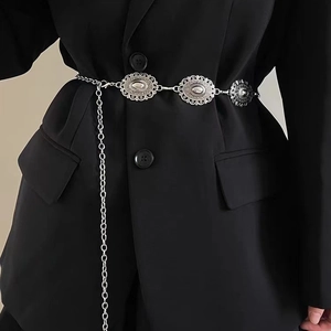 Vintage silver metal waist chain with embossed oval buckles on a black blazer