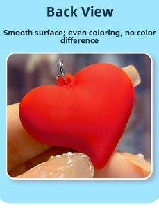 Detail view showing smooth red matte heart keychain with even coloring on back side