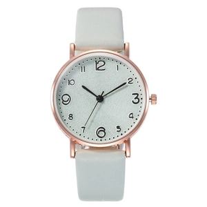 Close-up of rose gold watch case with silver dial and white leather strap details
