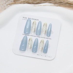Blue cat-eye press-on nails with silver floral butterfly design in almond shape