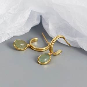 Detail of S925 silver gold hoops featuring green aventurine oval pendants in a retro style