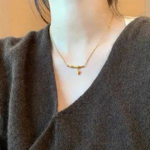 Gold titanium steel necklace featuring minimalist bamboo joint pendant with leaf detail