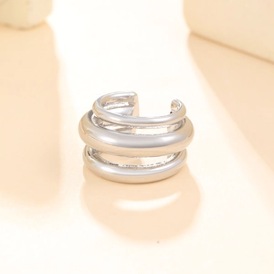 Detail view of silver multi-layer ear cuff with polished finish and open-loop design