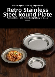 Close-up of retro stainless steel pasta plate showing brushed metal texture and rim