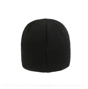 Rear view of black knitted beanie showing detailed fine-knit texture and ribbed cuff edge