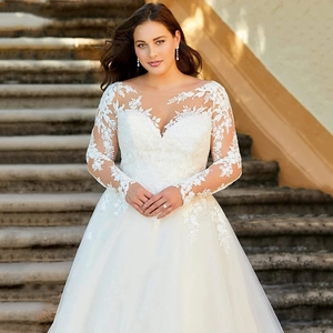 Elegant white V-neck lace wedding dress with long sleeves and cathedral train for outdoor weddings