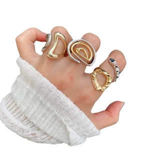 Set of four 18k gold plated geometric spiral rings with minimalist wavy design