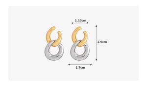 Detail view of interlocking C-shape dual-tone geometric earrings with size measurements