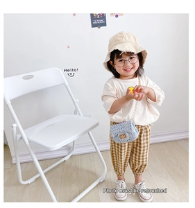 Detail of a light blue tweed crossbody bag for kids with gold chain strap accessory