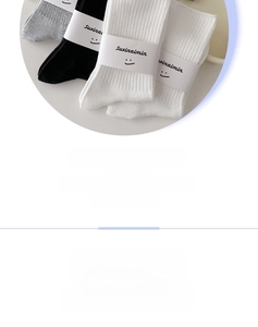 Detail of ribbed crew socks in grey, black and white with high-elastic cuffs and flat seams