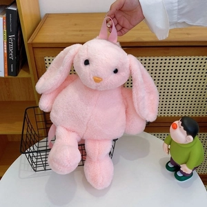Detail of pink plush bunny backpack featuring soft high-gram weight fur and webbing handle