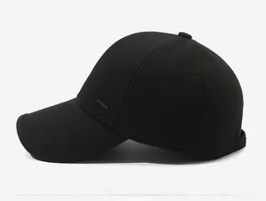 Detailed side view of black baseball cap with thermal lining and small metal logo plate