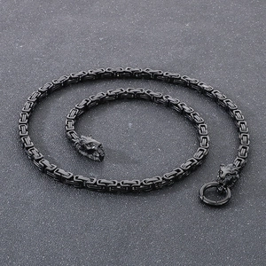 Macro detail of punk style square link chain with lion head charms and round clasp