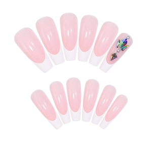 Long coffin French tip press-on nails with nude pink base and colorful rhinestone accents