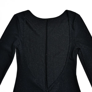 Detail of black glitter jumpsuit showing long sleeves, V-neck, and shimmering fabric texture