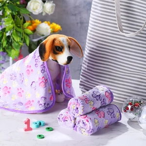 Detail of purple coral fleece pet towel with paw print pattern on beagle dog model