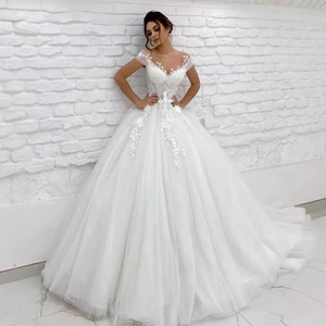 Elegant white lace wedding dress with voluminous tulle skirt and floral embroidery