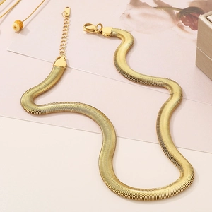 Flat lay of an 8mm golden snake bone chain necklace in minimalist hip-hop style