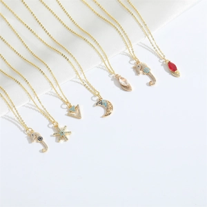 Gold pendant necklaces featuring seahorse, moon, and star designs with colorful crystals