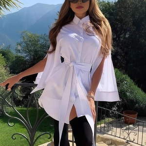 Detail of elegant white shirt dress with cape-style split sleeves and waist tie design