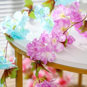 Vibrant artificial silk flower vines in pink and blue for home and wedding decor
